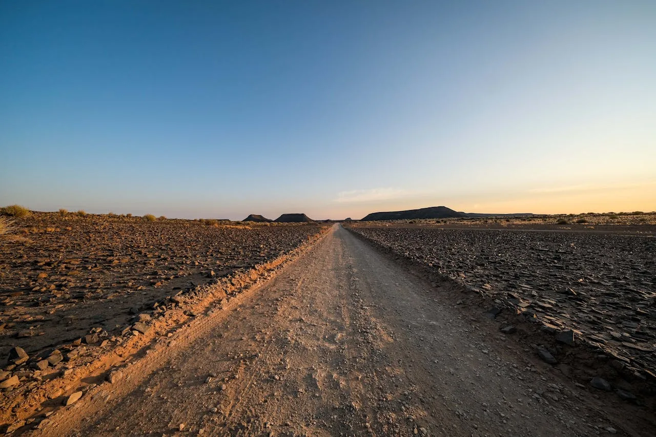 An open road stretching into the distance under a wide sky